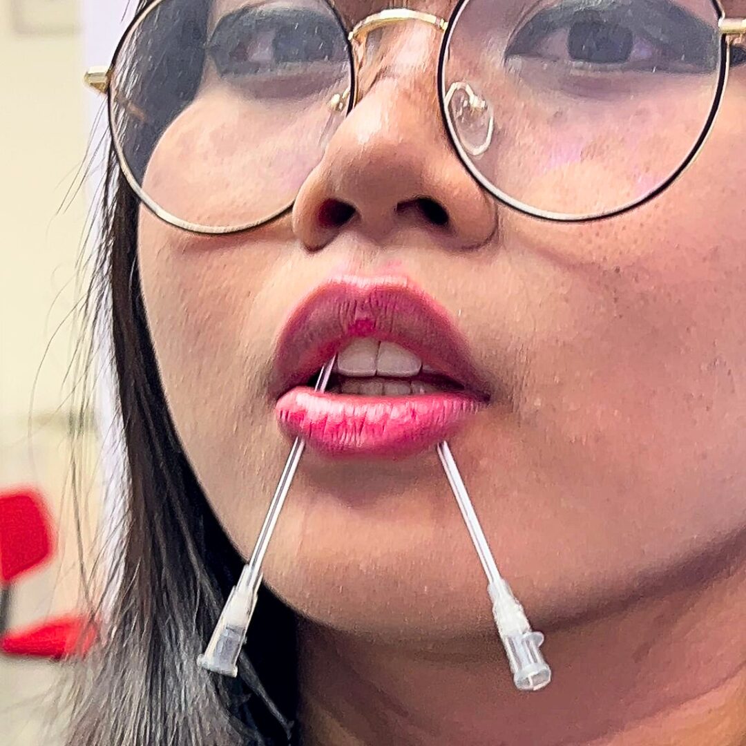 Performing a Snake Bites Piercing on the lip