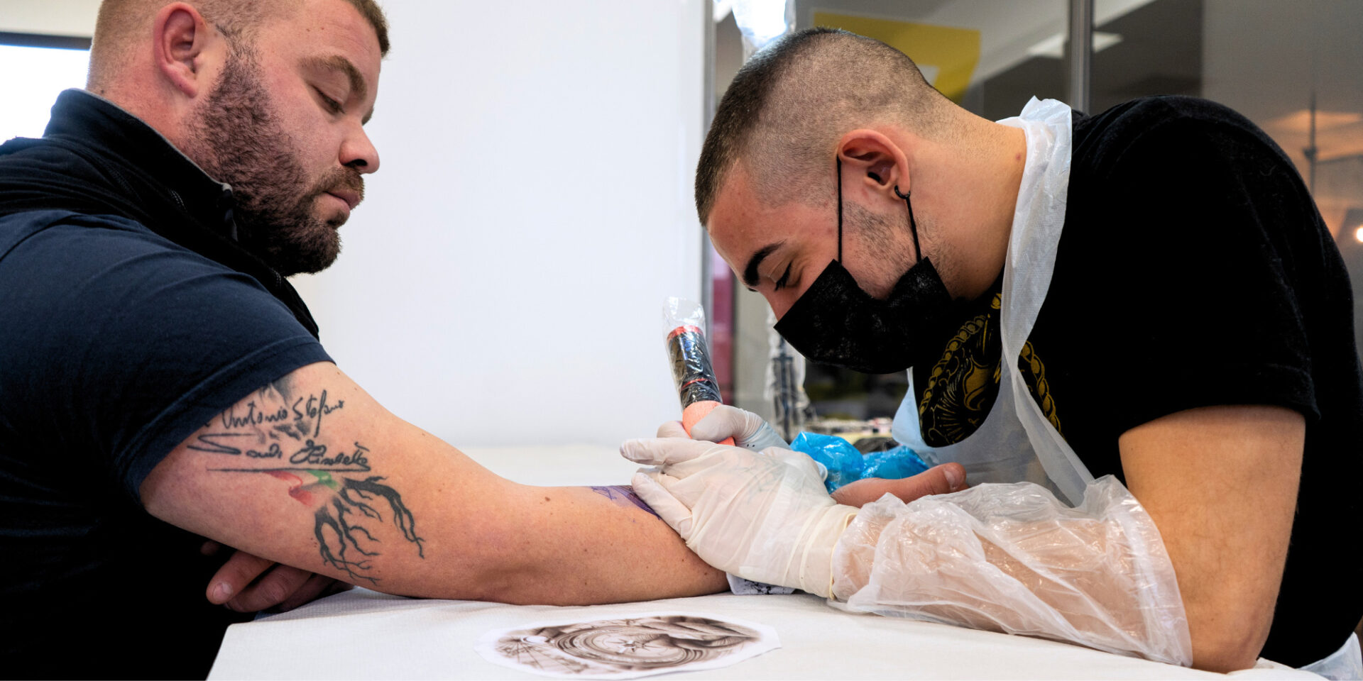 Professional showing how to care for a tattoo