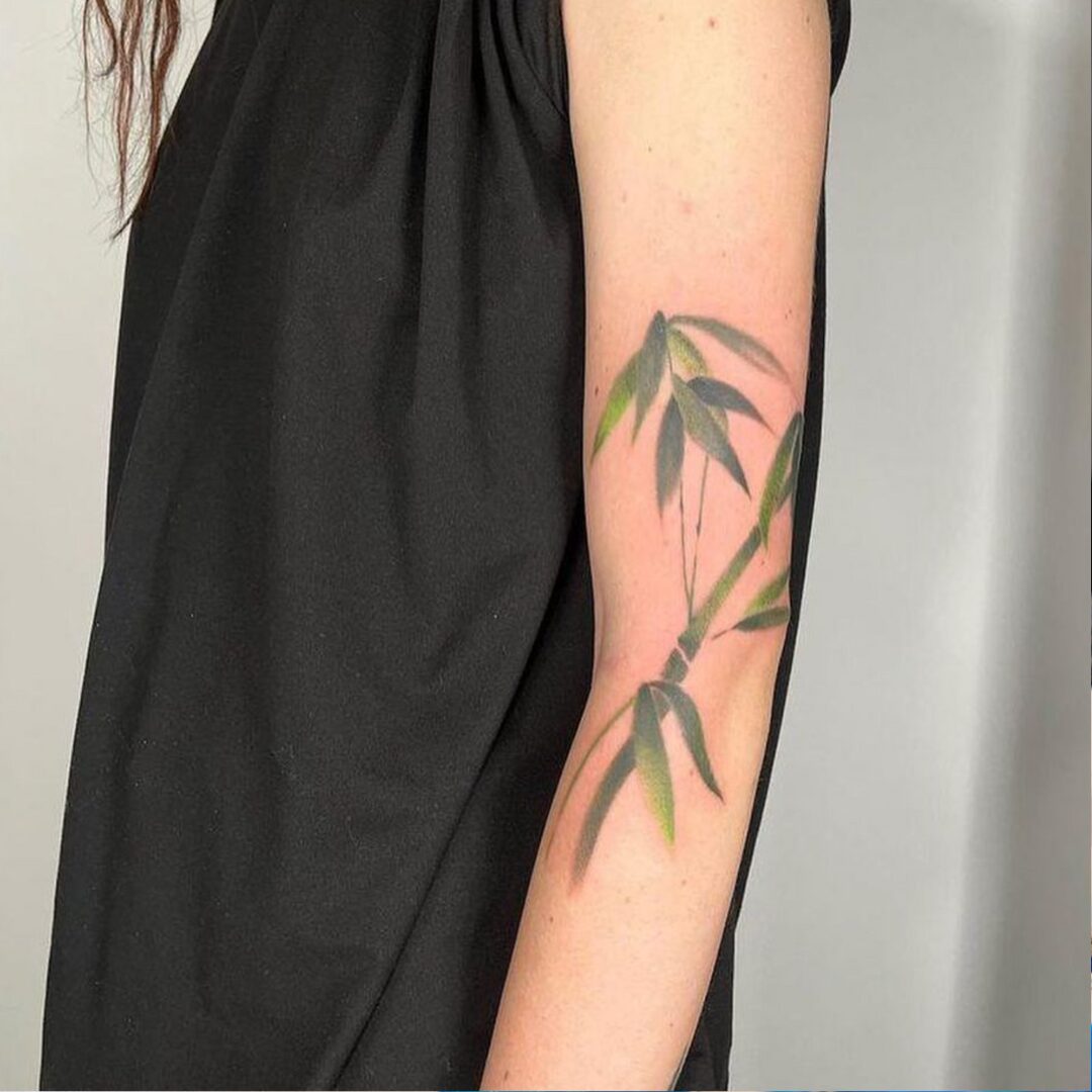 Painterly leaves tattoo on the arm