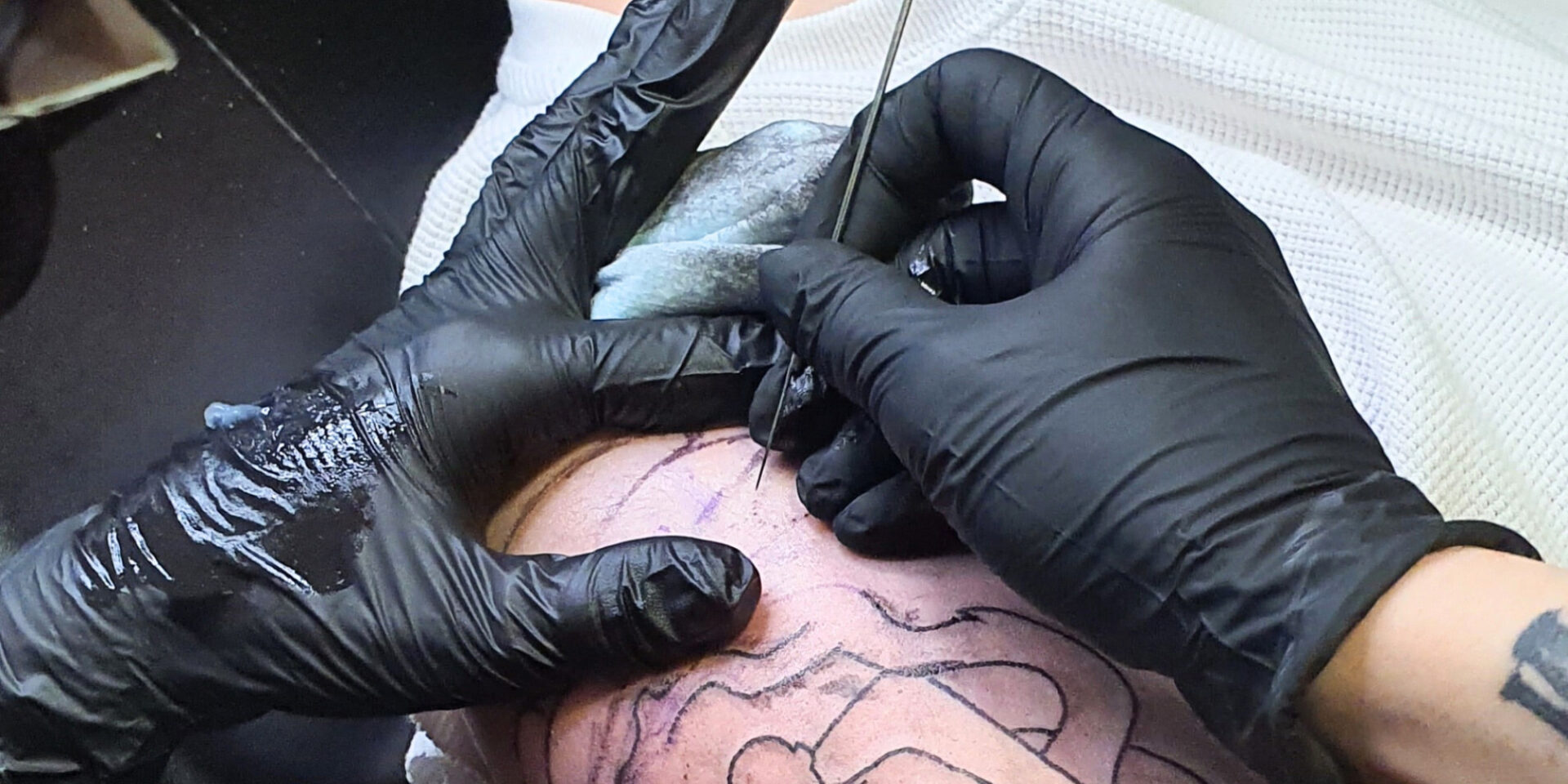 Execution of a hand poke tattoo