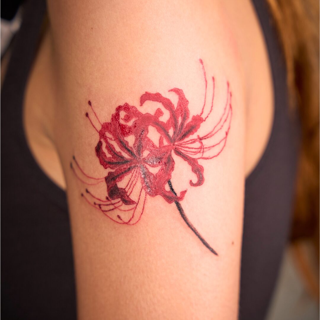 Painterly style flower tattoo on the arm